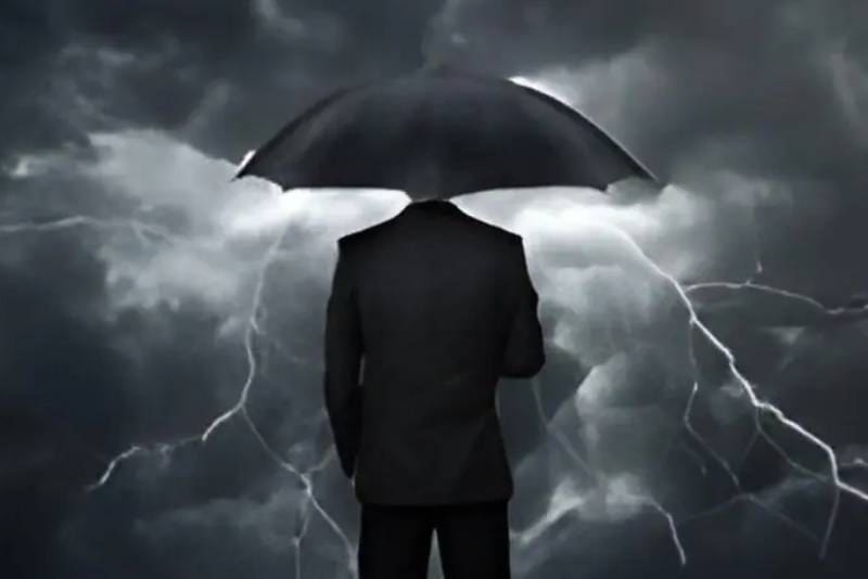 Businessman with umbrella in storm representing climate risk