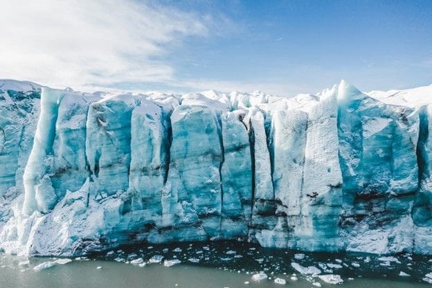 A large ice block is shown on the side of a glacier.